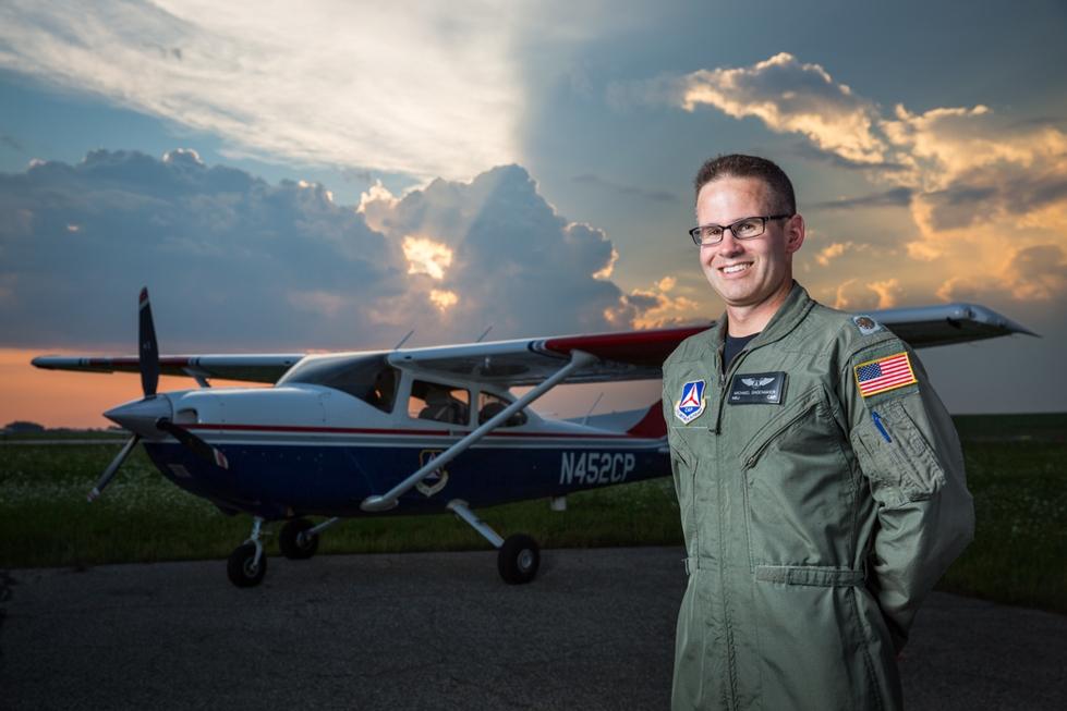 Michael Shoemaker in pilot uniform in front of plane